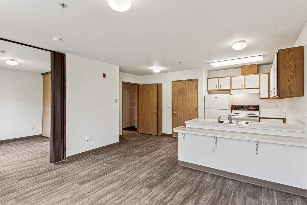 Kitchen and living area at Woodrose Senior Affordable Apartments in Bellingham WA